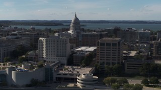 DX0002_160_018 - 5.7K aerial stock footage pass by convention center and office buildings and focus on the capitol building in Madison, Wisconsin
