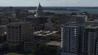 DX0002_160_019 - 5.7K aerial stock footage fly near office buildings and focus on the capitol building in Madison, Wisconsin