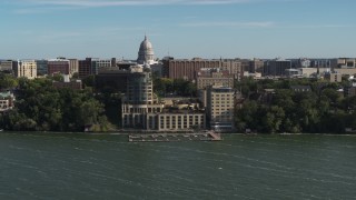 DX0002_160_028 - 5.7K aerial stock footage approach a lakeside hotel in Madison, Wisconsin with capitol dome in background