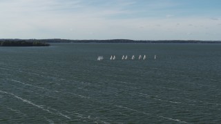 DX0002_160_035 - 5.7K aerial stock footage of a reverse view of a group of sailboats on Lake Mendota, Madison, Wisconsin