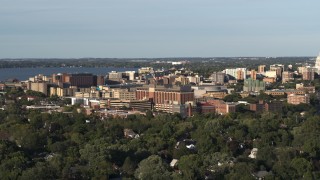 DX0002_161_013 - 5.7K aerial stock footage of orbiting a hospital near downtown during ascent, Madison, Wisconsin