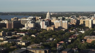DX0002_161_019 - 5.7K aerial stock footage ascend and flyby the capitol dome and downtown buildings, Madison, Wisconsin