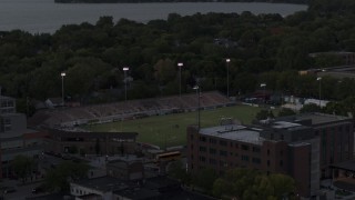 DX0002_162_008 - 5.7K aerial stock footage orbit and fly away from a soccer stadium at twilight, Madison, Wisconsin