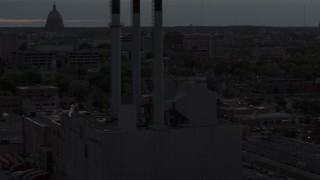 DX0002_162_011 - 5.7K aerial stock footage orbit power plant smoke stacks at twilight, Madison, Wisconsin
