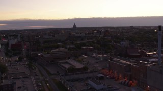 DX0002_162_019 - 5.7K aerial stock footage approach capitol dome from power plant smoke stacks at twilight, Madison, Wisconsin