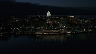 DX0002_162_031 - 5.7K aerial stock footage a reverse view of the capitol dome and convention center at night, Madison, Wisconsin