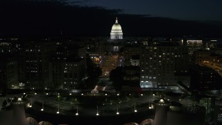 DX0002_162_034 - 5.7K aerial stock footage passing downtown buildings while focused on the capitol at night, Madison, Wisconsin
