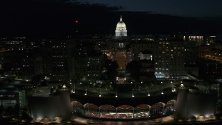 DX0002_162_036 - 5.7K aerial stock footage flyby convention center while focused on the capitol at night, Madison, Wisconsin