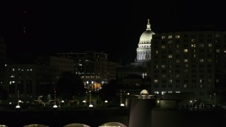 DX0002_162_048 - 5.7K aerial stock footage of the capital dome at night while flying by hotel, Madison, Wisconsin