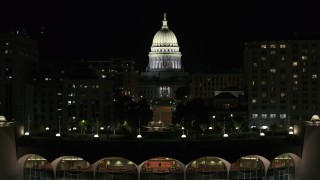 DX0002_162_049 - 5.7K aerial stock footage focus on the capital at night, descend to reveal convention center, Madison, Wisconsin