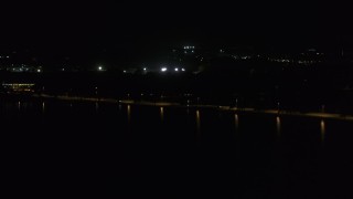 DX0002_162_054 - 5.7K aerial stock footage of a causeway on the lake at night, Madison, Wisconsin