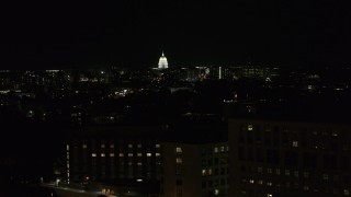 DX0002_163_015 - 5.7K aerial stock footage ascend by hospital at night while focused on capitol, Madison, Wisconsin