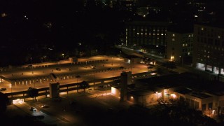 DX0002_163_018 - 5.7K aerial stock footage of an orbit of a hospital and parking garage at night, Madison, Wisconsin