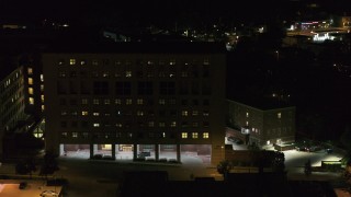 DX0002_163_023 - 5.7K aerial stock footage descend by a hospital complex at night, Madison, Wisconsin