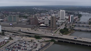 DX0002_164_004 - 5.7K aerial stock footage a view of apartment high-rise and office buildings near bridges and river, Downtown Cedar Rapids, Iowa