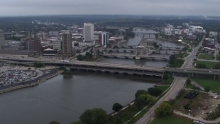 DX0002_164_007 - 5.7K stock footage aerial video of flying by bridges spanning the river by Downtown Cedar Rapids, Iowa