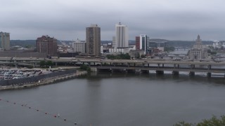 DX0002_164_013 - 5.7K aerial stock footage view of apartment high-rise and bridges spanning the river during descent, Downtown Cedar Rapids, Iowa