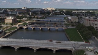DX0002_165_010 - 5.7K stock footage aerial video flyby and away from three bridges spanning the river in Des Moines, Iowa