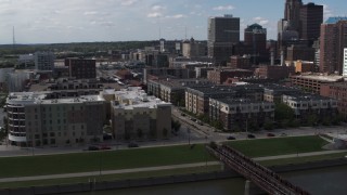 DX0002_165_014 - 5.7K stock footage aerial video orbit hotels and apartment complex near the skyline of Downtown Des Moines, Iowa