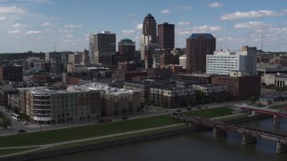 DX0002_165_015 - 5.7K stock footage aerial video slow orbit of hotels and apartment complex, reveal skyline of Downtown Des Moines, Iowa