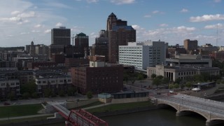DX0002_165_017 - 5.7K stock footage aerial video descend toward river with view of government offices and skyline, Downtown Des Moines, Iowa