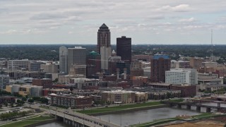 DX0002_165_031 - 5.7K stock footage aerial video of flying by the Cedar River while focused on skyline of Downtown Des Moines, Iowa