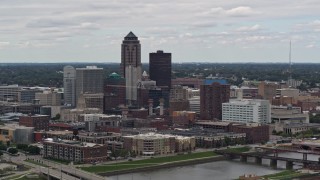 DX0002_165_032 - 5.7K stock footage aerial video of passing the Cedar River while focused on skyline of Downtown Des Moines, Iowa