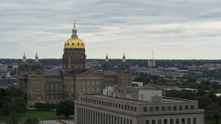 DX0002_166_014 - 5.7K aerial stock footage ascend by government office building for view of the Iowa State Capitol, Des Moines, Iowa