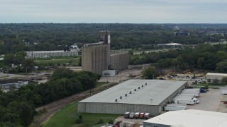 DX0002_166_024 - 5.7K aerial stock footage of a grain elevator and warehouse building in Des Moines, Iowa