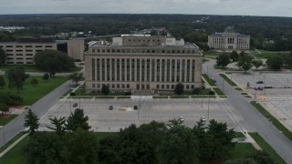 DX0002_166_031 - 5.7K aerial stock footage orbit and fly away from a state government office building, Des Moines, Iowa