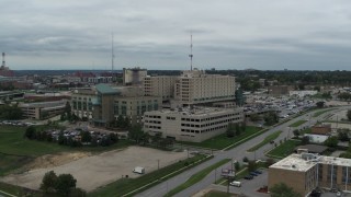 DX0002_166_043 - 5.7K aerial stock footage of ascending away from a hospital in Des Moines, Iowa