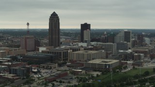 DX0002_167_018 - 5.7K stock footage aerial video flying by a towering skyscraper and office buildings in Downtown Des Moines, Iowa