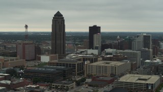 DX0002_167_019 - 5.7K stock footage aerial video passing by a towering skyscraper and office buildings in Downtown Des Moines, Iowa