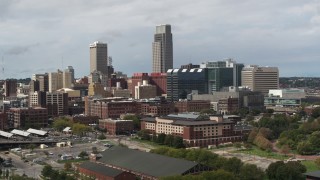DX0002_168_010 - 5.7K aerial stock footage of passing by skyscraper and downtown skyline in Downtown Omaha, Nebraska