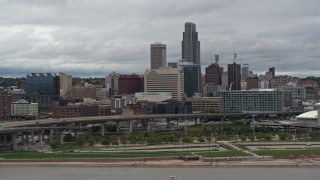 DX0002_169_002 - 5.7K aerial stock footage of flying by a riverfront park with a view of skyline, Downtown Omaha, Nebraska