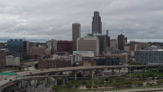 DX0002_169_003 - 5.7K aerial stock footage of passing a riverfront park with a view of skyline, Downtown Omaha, Nebraska