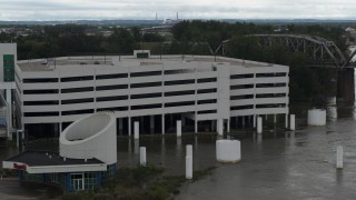 DX0002_169_012 - 5.7K aerial stock footage of orbiting a flooded parking garage in Council Bluffs, Iowa