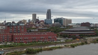DX0002_169_035 - 5.7K aerial stock footage of the city's skyline and riverfront apartment complex seen from river, Downtown Omaha, Nebraska