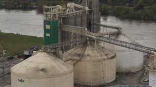 DX0002_170_009 - 5.7K aerial stock footage approach storage tanks and grain elevator by river, Council Bluffs, Iowa
