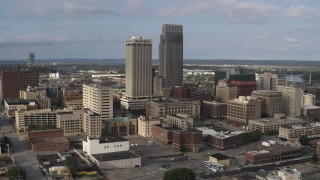 DX0002_170_022 - 5.7K aerial stock footage of flying by skyscrapers towering over city buildings in Downtown Omaha, Nebraska