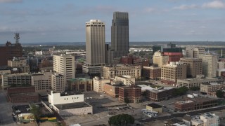 DX0002_170_024 - 5.7K stock footage aerial video of slowly orbiting skyscrapers towering over city buildings in Downtown Omaha, Nebraska