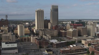DX0002_170_025 - 5.7K aerial stock footage of a stationary view of skyscrapers towering over city buildings in Downtown Omaha, Nebraska