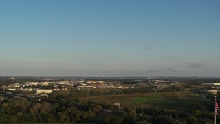 DX0002_172_002 - 5.7K aerial stock footage of a wide, reverse view of the city at sunset, Council Bluffs, Iowa