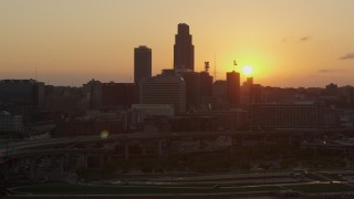 DX0002_172_031 - 5.7K aerial stock footage slowly orbit the skyline, setting sun in background, Downtown Omaha, Nebraska