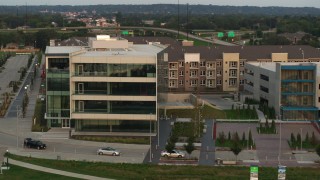 DX0002_172_034 - 5.7K aerial stock footage of circling a modern office building at sunset in Council Bluffs, Iowa