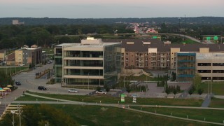 DX0002_172_036 - 5.7K aerial stock footage orbit a modern office building at sunset in Council Bluffs, Iowa