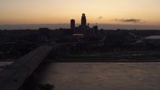 DX0002_172_037 - 5.7K aerial stock footage approach skyline from bridge over the river at twilight, Downtown Omaha, Nebraska