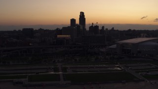 DX0002_172_038 - 5.7K aerial stock footage of the skyline, reveal arena and convention center at twilight, Downtown Omaha, Nebraska