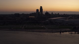 DX0002_172_039 - 5.7K aerial stock footage reverse view of the skyline, arena and convention center at twilight, Downtown Omaha, Nebraska