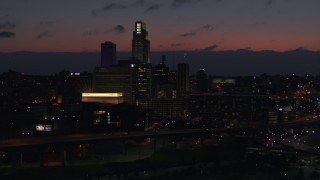 DX0002_173_008 - 5.7K aerial stock footage of flying away from the city's skyline at twilight, Downtown Omaha, Nebraska